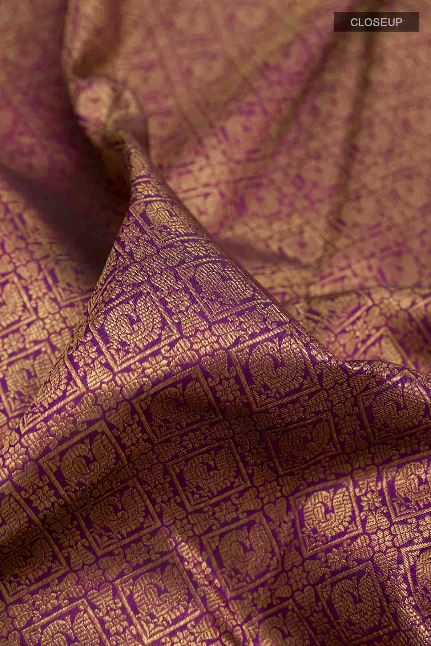 Close up of Pure Silk Pure Zari Purple Kanchipuram Saree with Zari Brocade on the body and Zari Border displaying folds
