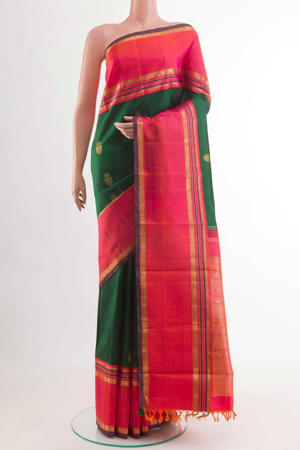 Green Kanchipuram Silk Saree with Zari Butta on the body and Zari Border displayed on a mannequin