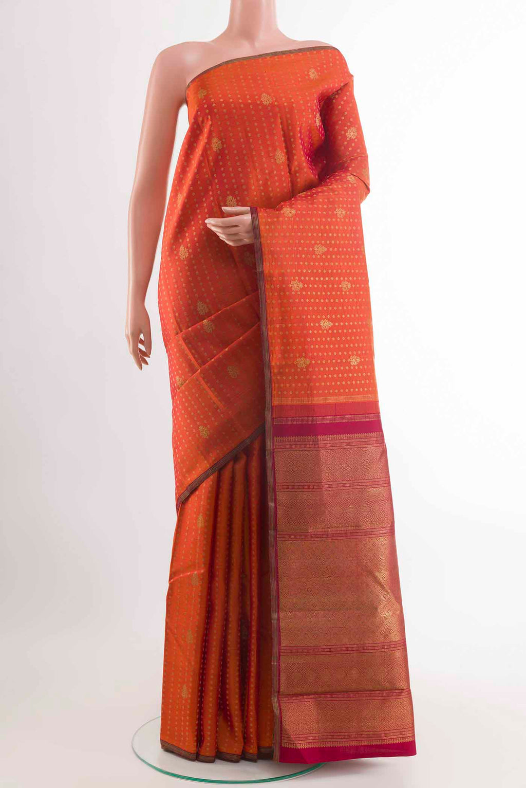 Orange Kanchipuram Silk Saree with Zari Butta on the body and Zari Border displayed on a mannequin