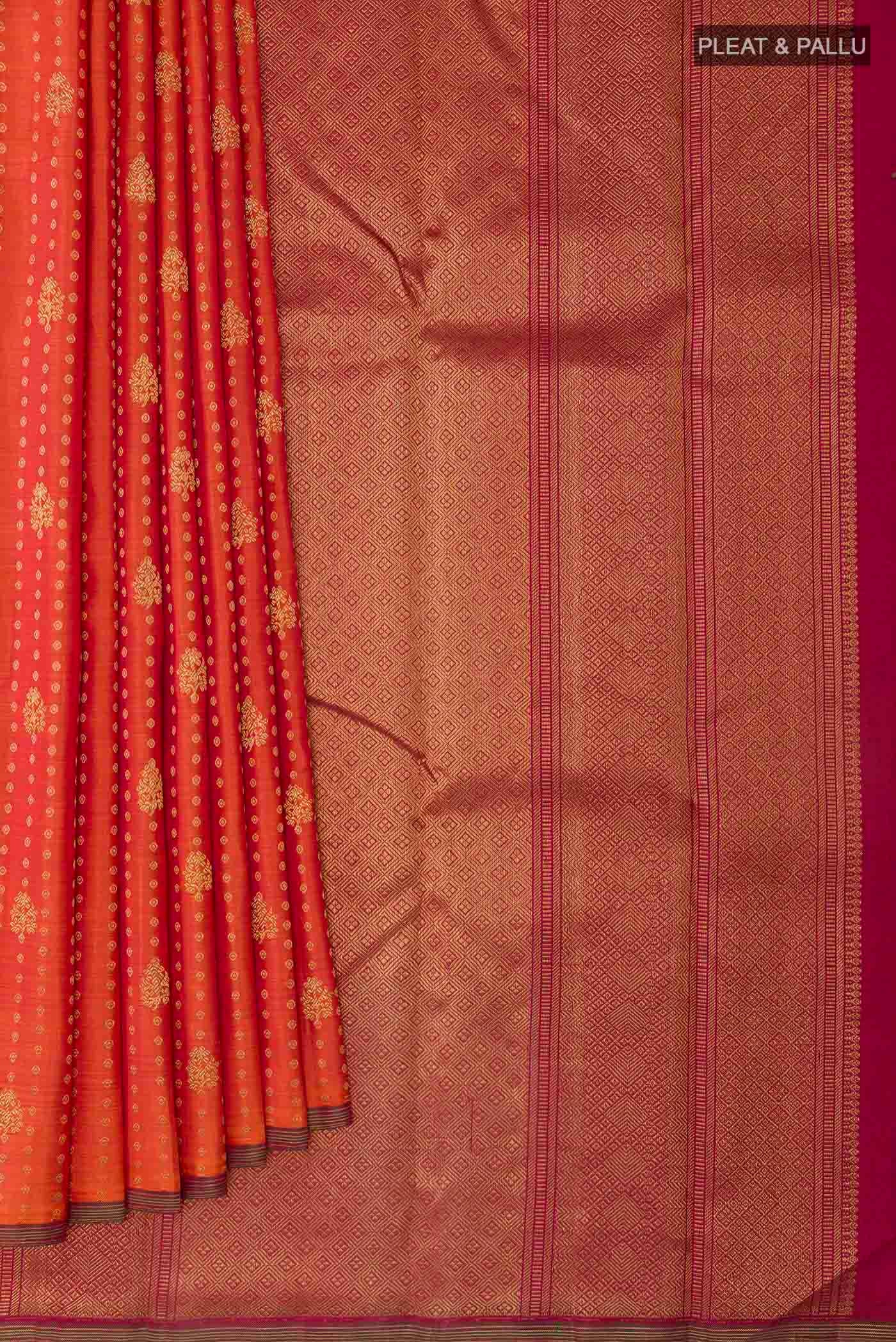 Pleats and pallu of Orange Kanchipuram Silk Saree with Zari Butta on the body and Zari Border