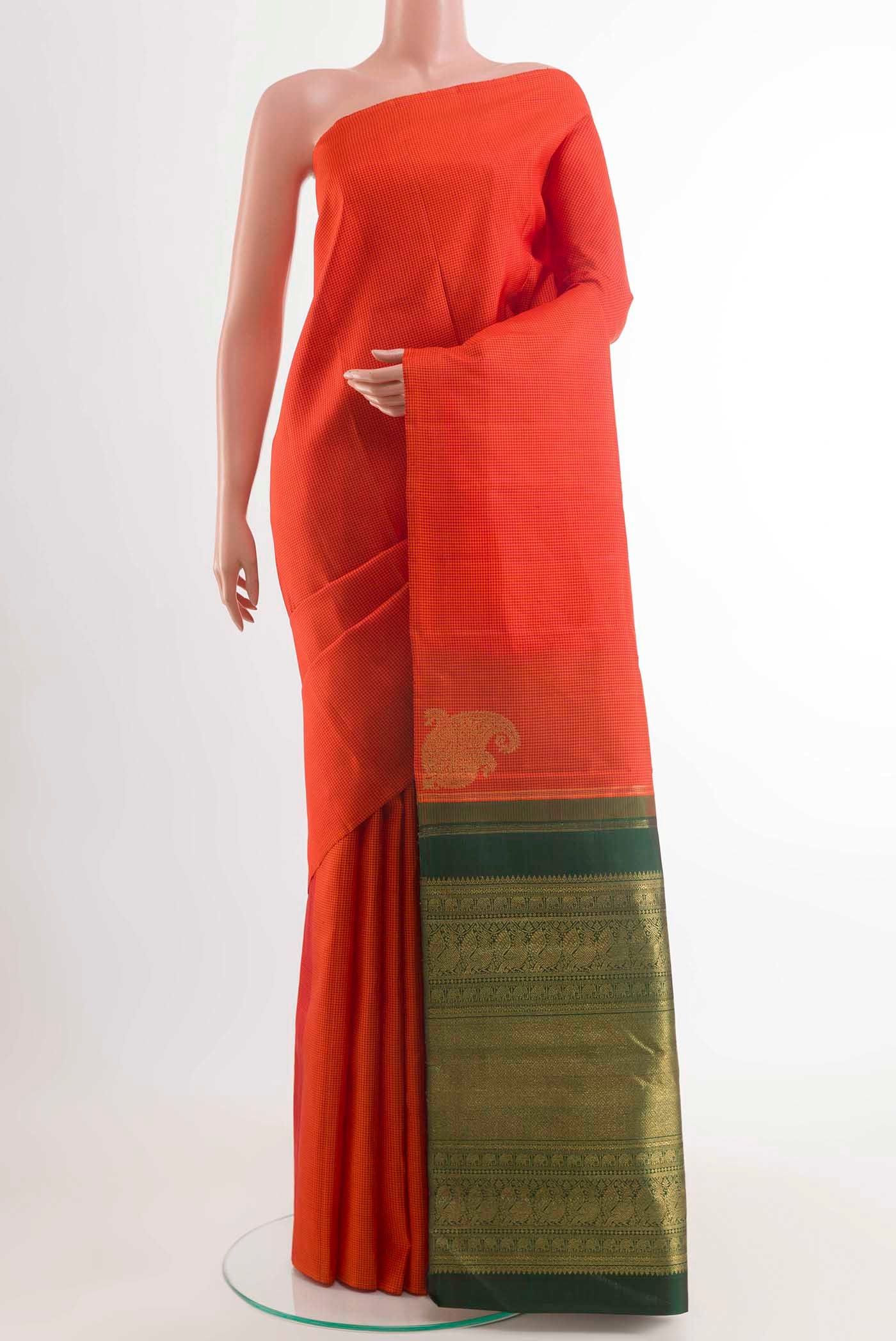 Orange Kanchipuram Silk Saree with Checked design on the body and Without Border displayed on a mannequin