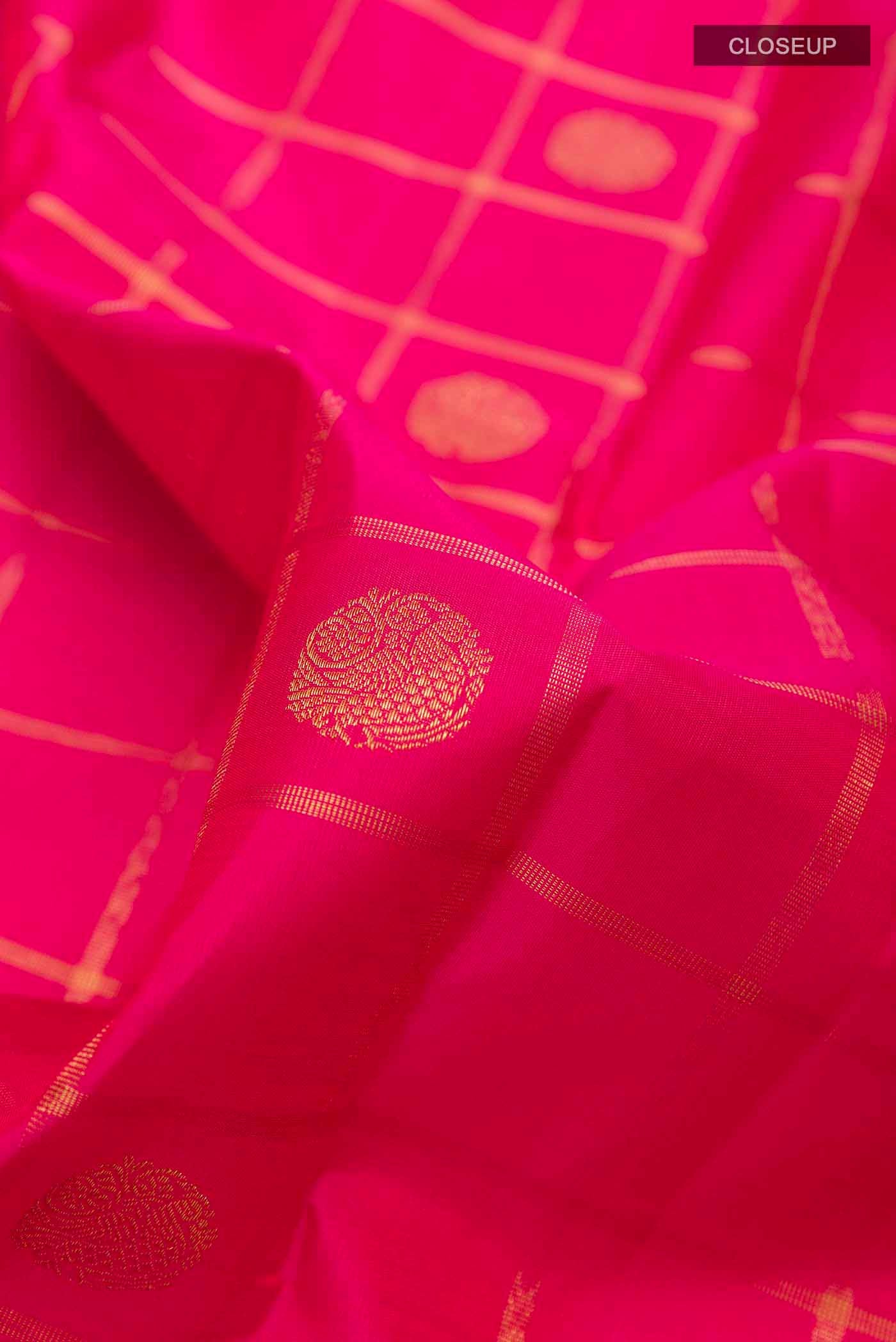 Close up of Pink Kanchipuram Silk Saree with Zari Butta on the body and Without Border displaying folds