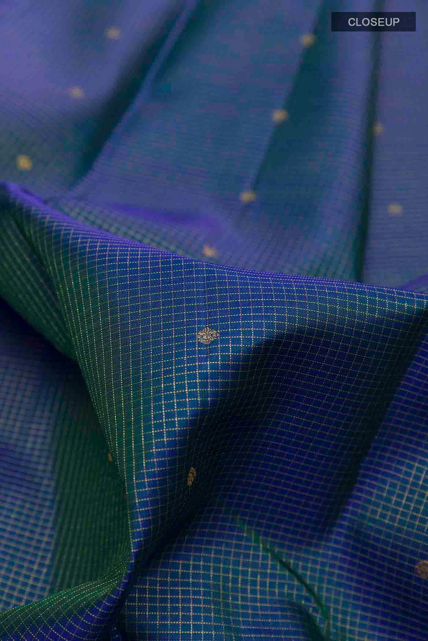 Close up of Pure Silk Pure Zari Peacock Blue Kanchipuram Saree with Zari Butta on the body and Zari Border displaying folds