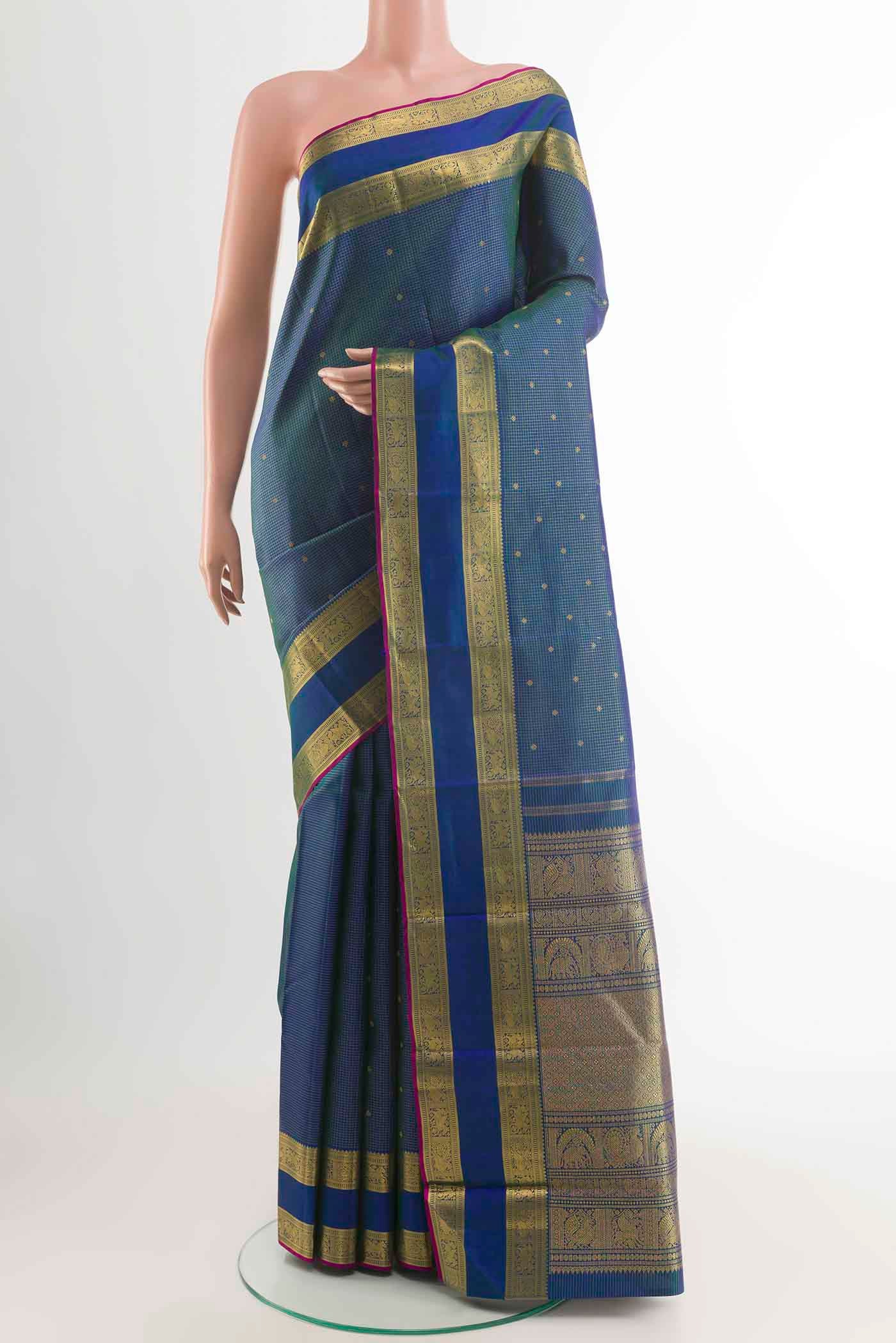 Pure Silk Pure Zari Peacock Blue Kanchipuram Saree with Zari Butta on the body and Zari Border displayed on a mannequin
