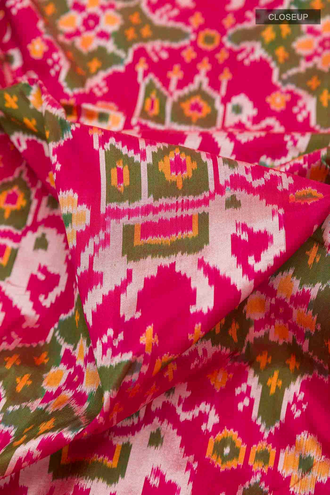 Close up of Pink Pochampally Silk Saree with Pure Ikat on the body and Zari Border displaying folds