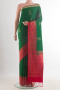 Pure Silk Green Soft Saree with Zari Butta on the body and Zari Border.  displayed on a mannequin