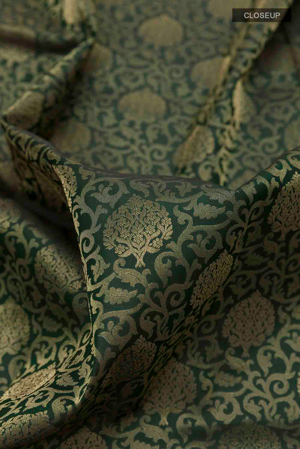 Close up of Green Soft Silk Saree with Zari Brocade on the body and Zari Border displaying folds