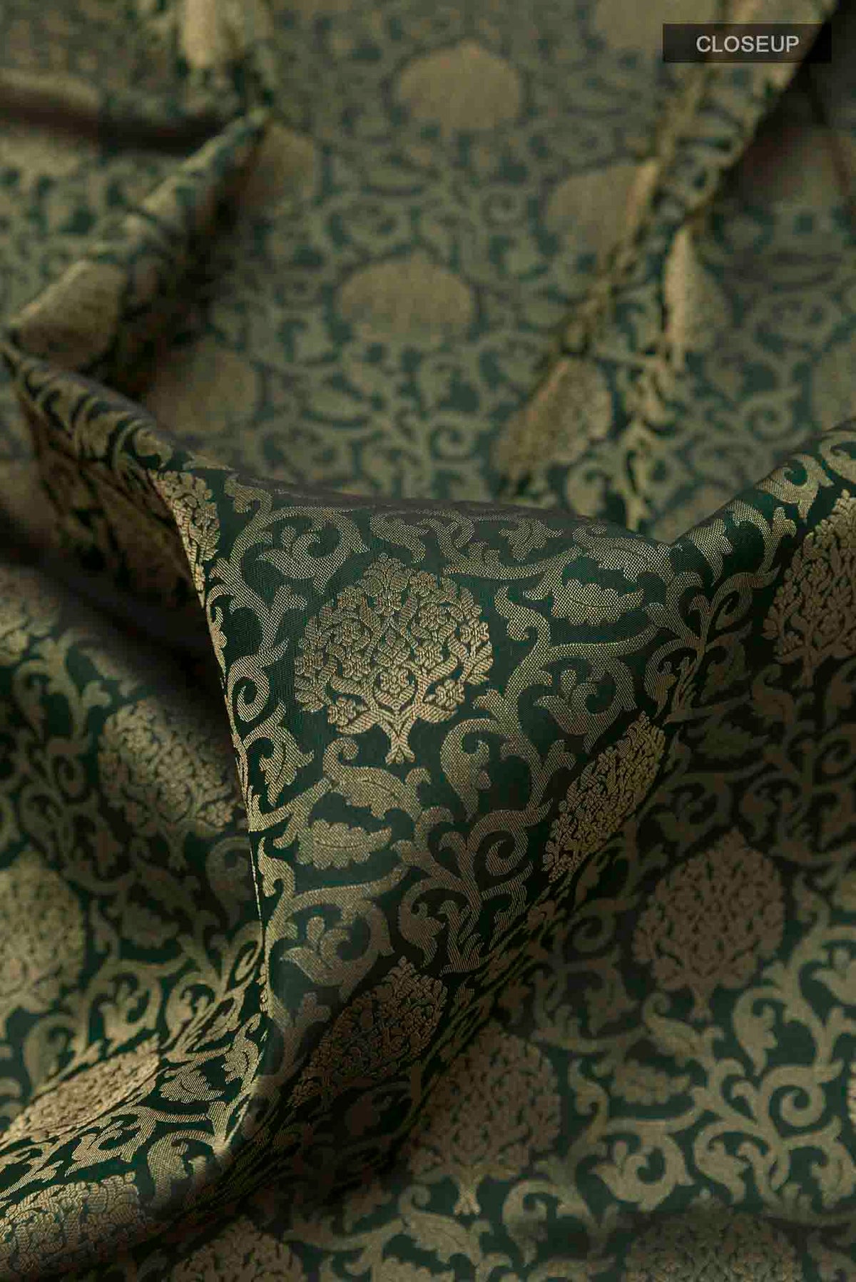 Close up of Green Soft Silk Saree with Zari Brocade on the body and Zari Border displaying folds