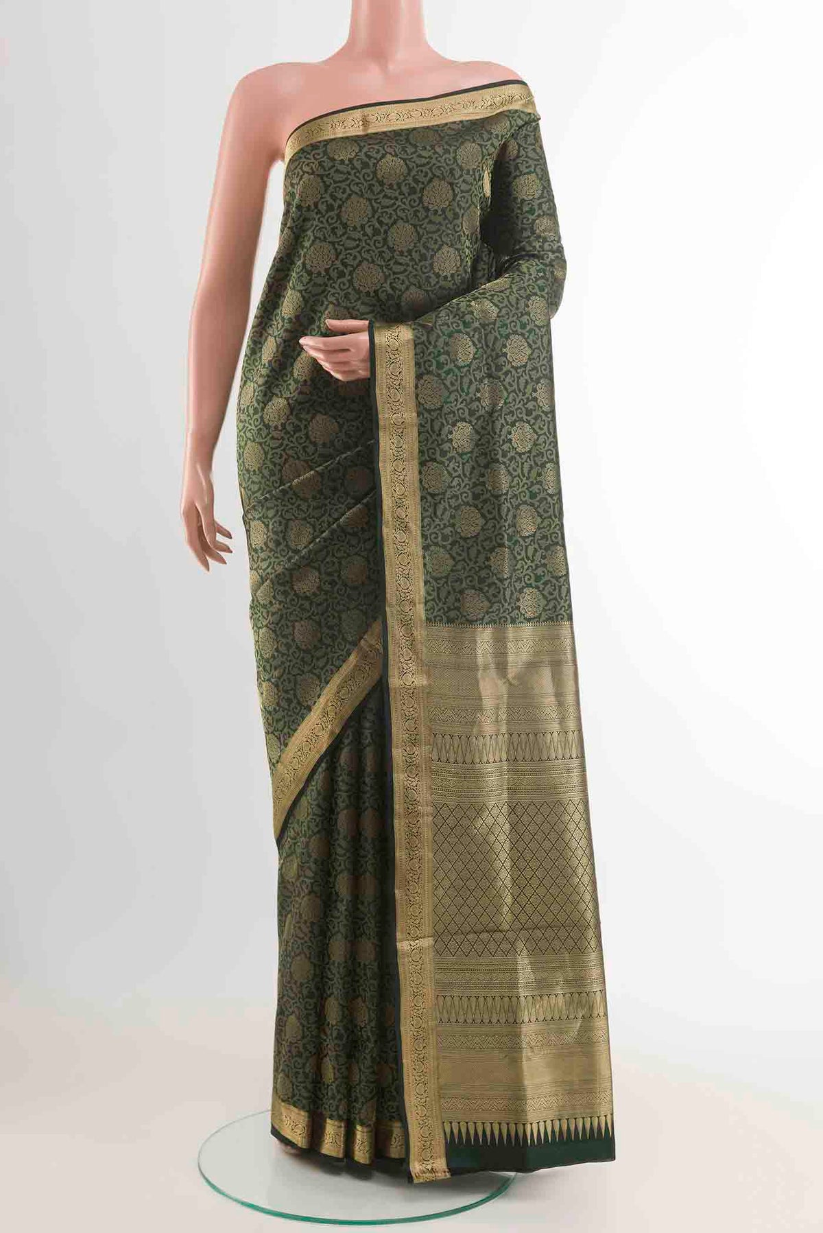Green Soft Silk Saree with Zari Brocade on the body and Zari Border displayed on a mannequin