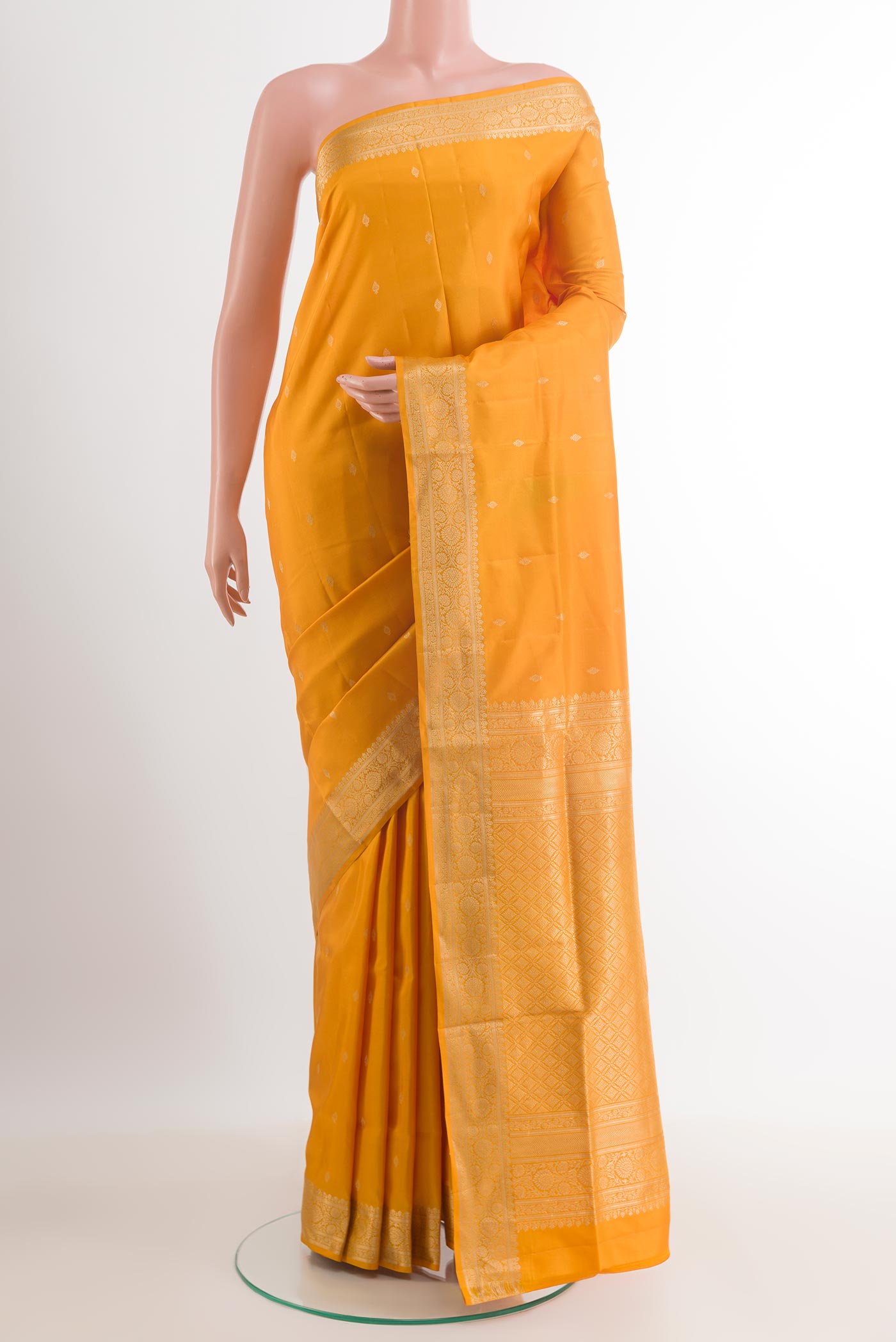 Yellow Soft Silk Saree with Zari Butta on the body and Zari Border.  displayed on a mannequin