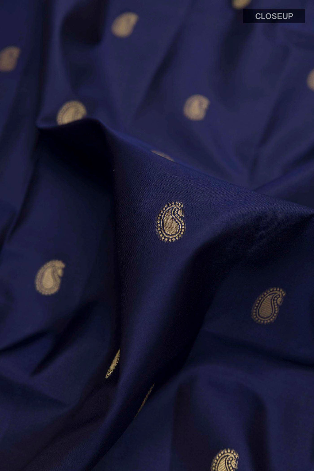 Close up of Blue Soft Silk Saree with Zari Butta on the body and Zari Border displaying folds