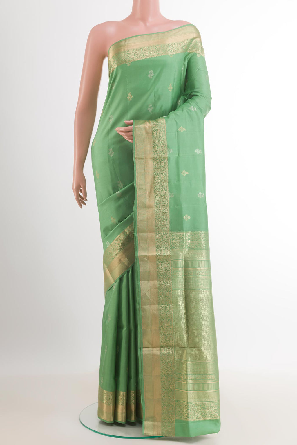 Light Green Soft Silk Saree with Zari Butta on the body and Zari Border.  displayed on a mannequin