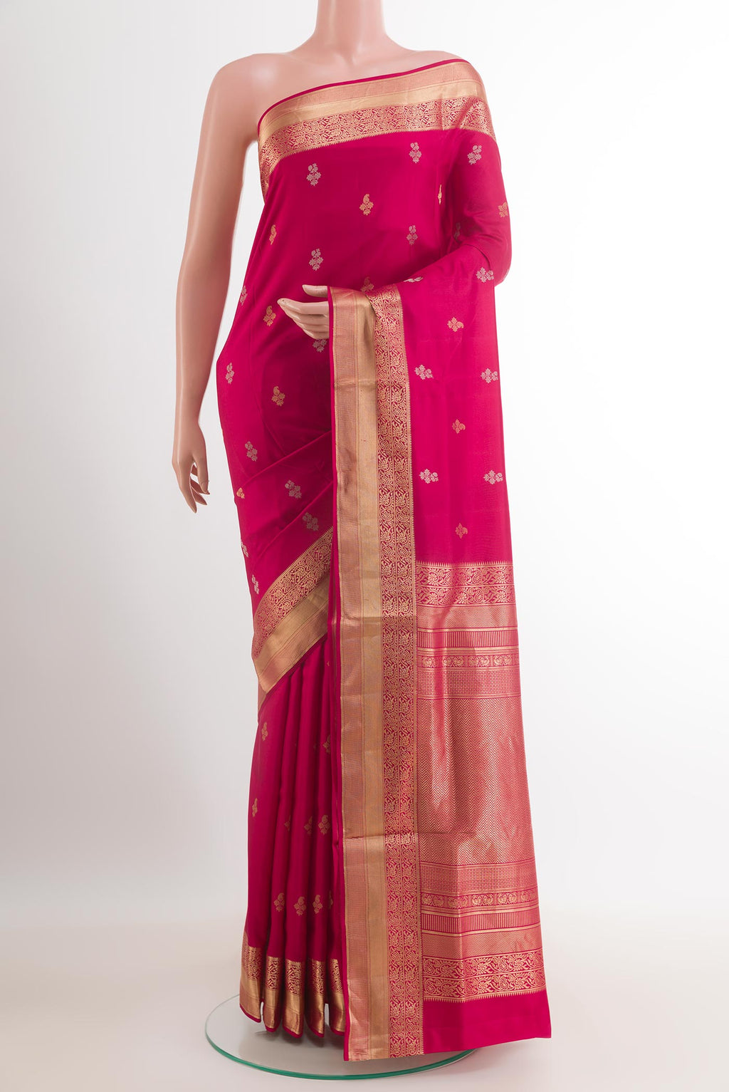 Rani Pink Soft Silk Saree with Zari Butta on the body and Zari Border.  displayed on a mannequin