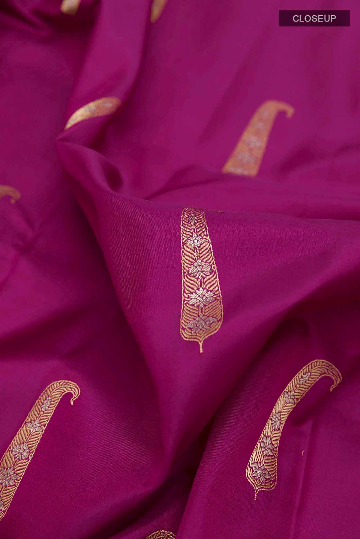 Close up of Purple Soft Silk Saree with Zari Butta on the body and Zari Border displaying folds
