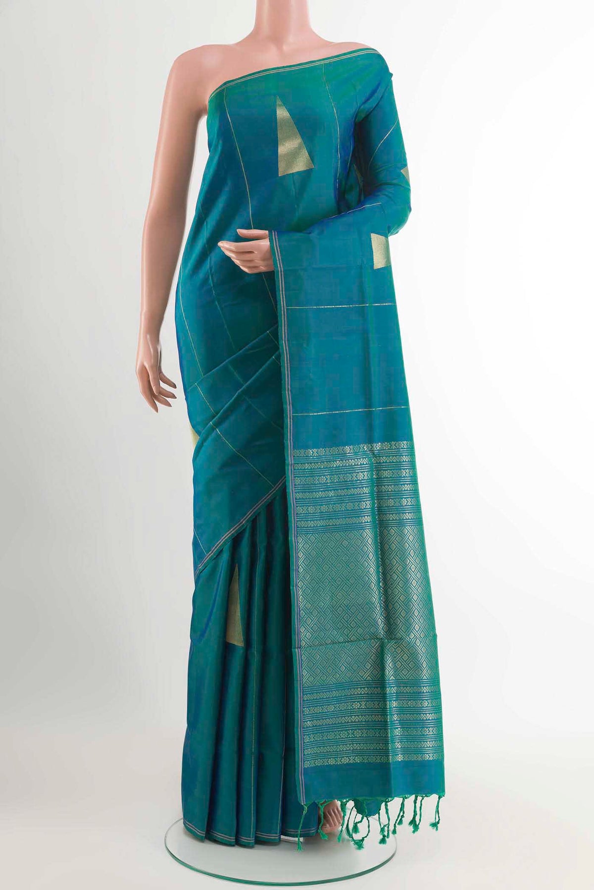 Peacock Blue Soft Silk Saree with Zari Butta on the body and Zari Border displayed on a mannequin