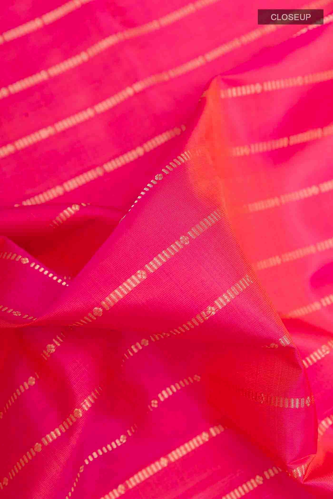 Close up of Pink Soft Silk Saree with Stripes on the body and Zari Border displaying folds