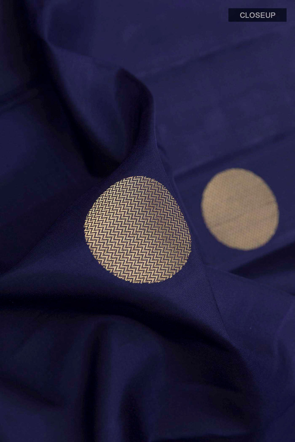 Close up of Blue Soft Silk Saree with Zari Butta on the body and Zari Border displaying folds