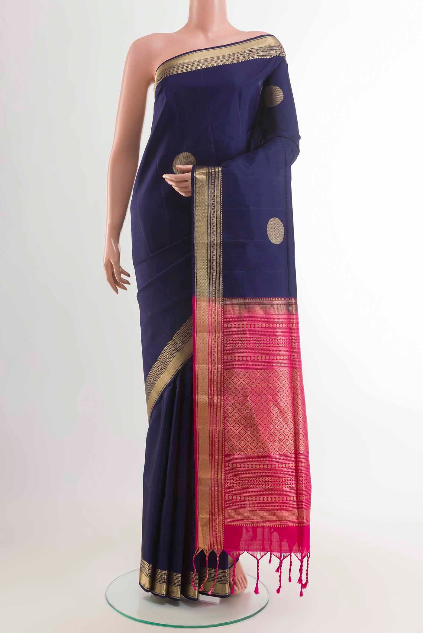 Blue Soft Silk Saree with Zari Butta on the body and Zari Border displayed on a mannequin