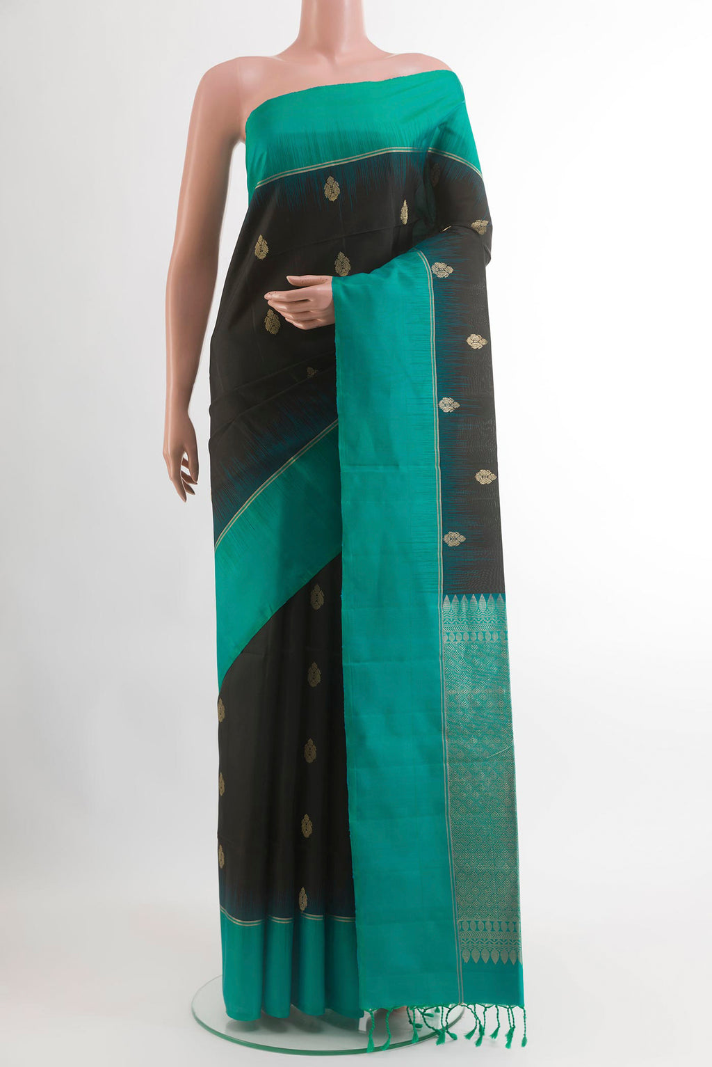 Black Soft Silk Saree with Zari Butta on the body and Zari Border.  displayed on a mannequin