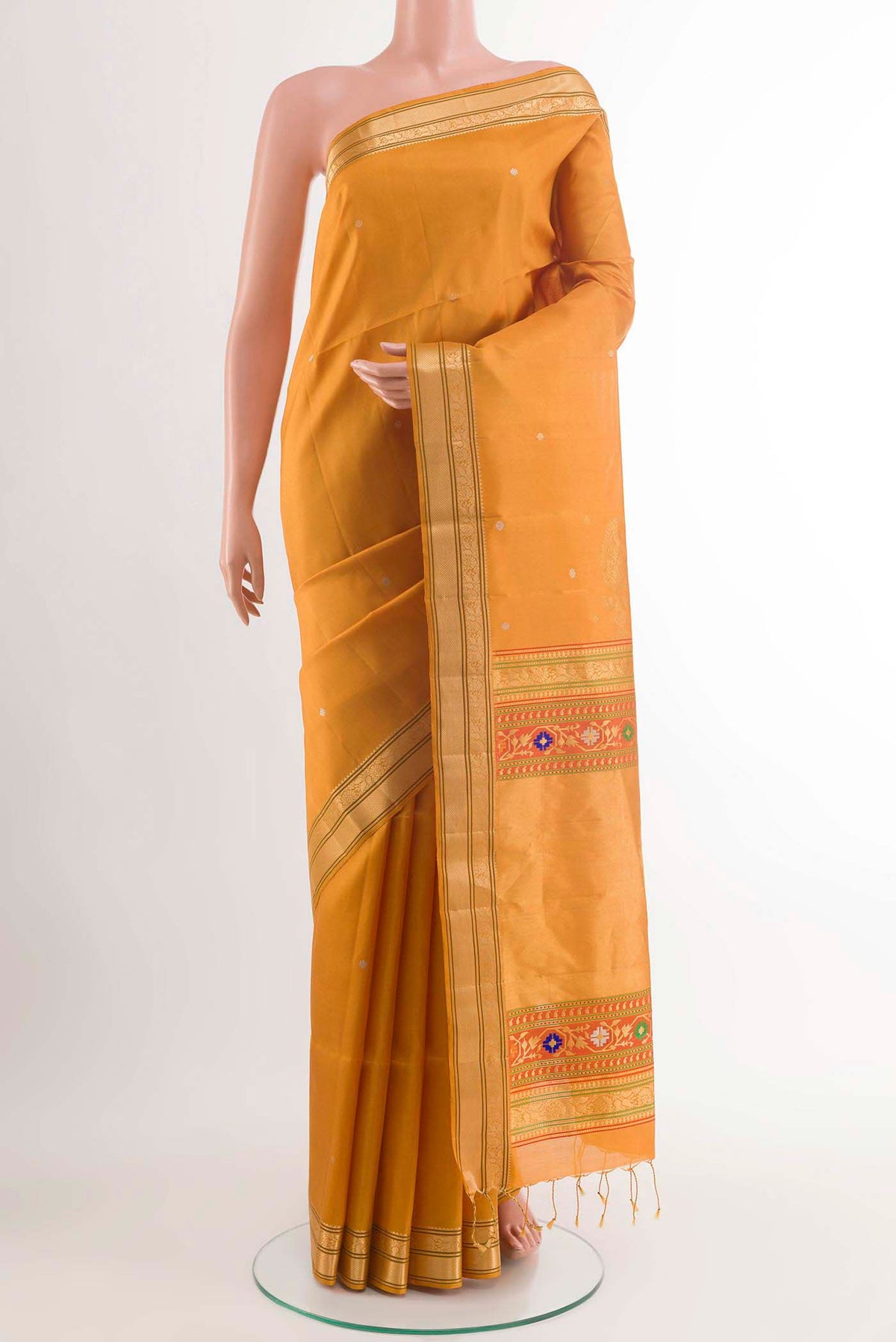 Mustard Soft Silk Saree with Zari Butta on the body and Zari Border displayed on a mannequin