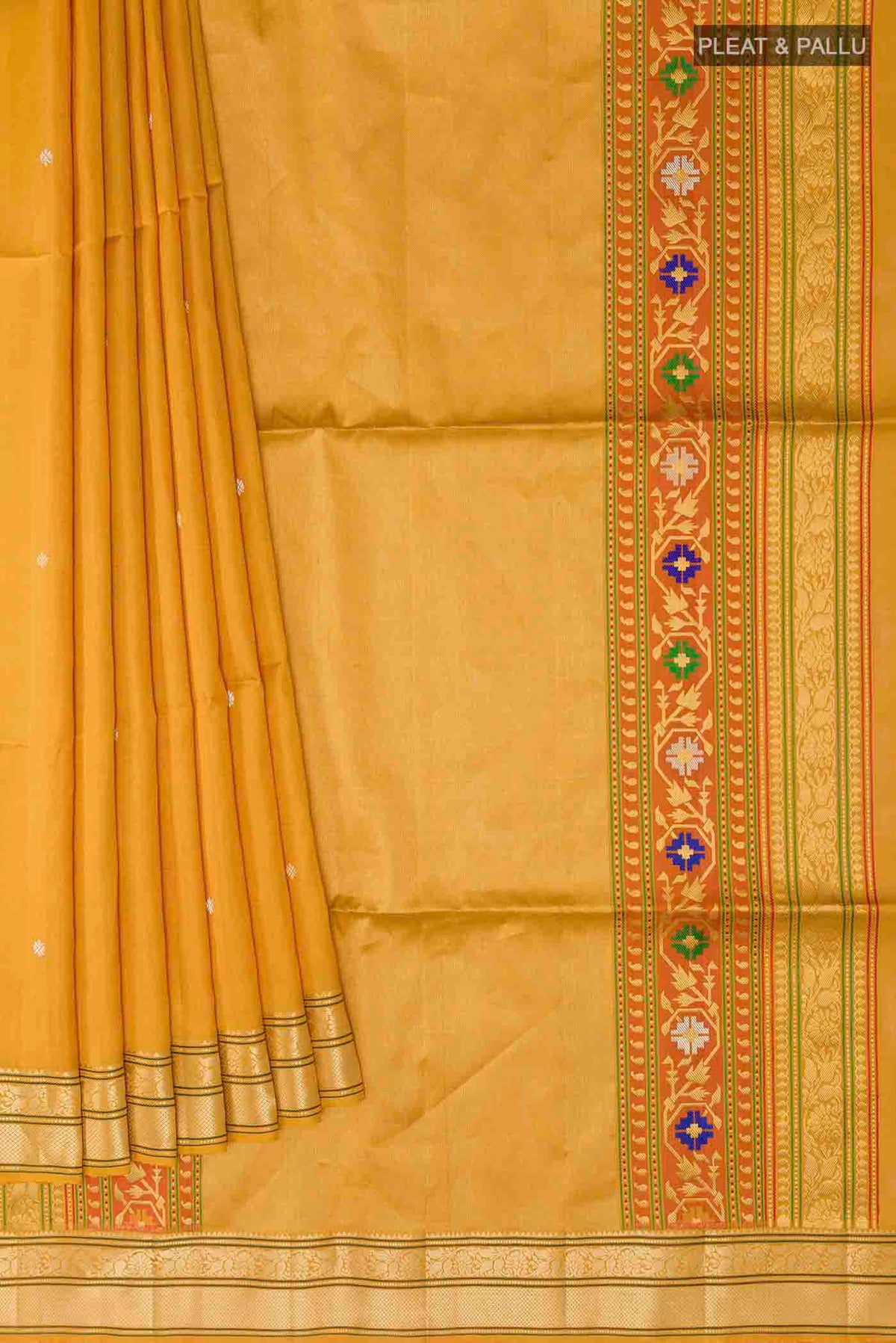Pleats and pallu of Mustard Soft Silk Saree with Zari Butta on the body and Zari Border
