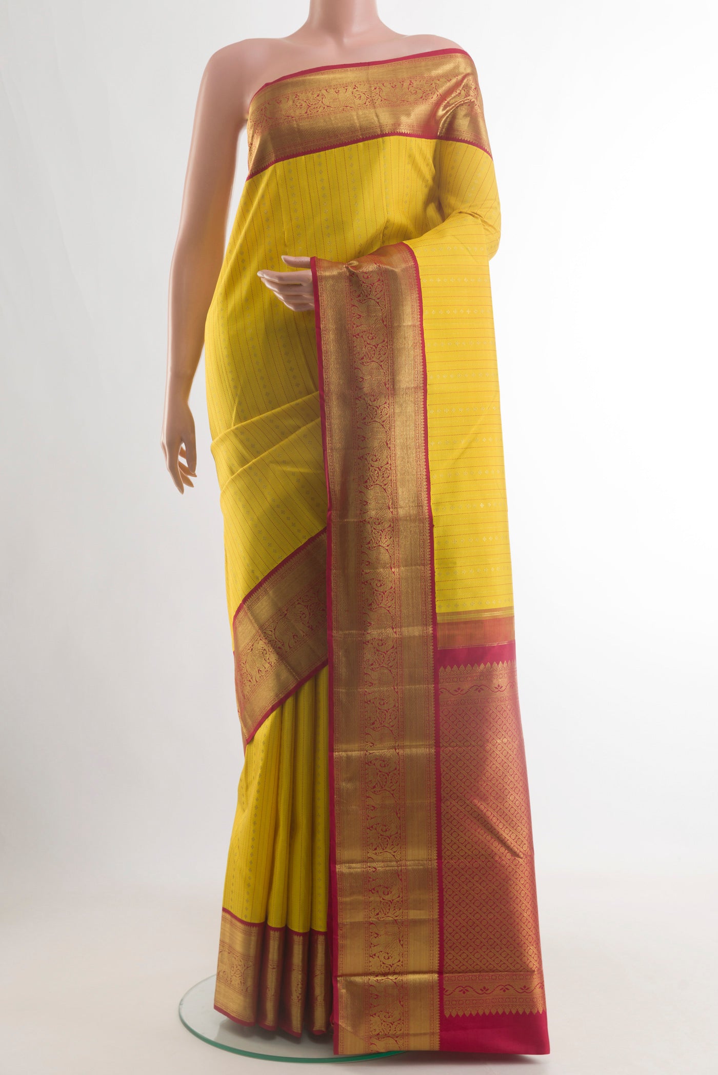 Yellow Kanchipuram Silk Saree with Stripes on the body and Zari Border.  displayed on a mannequin