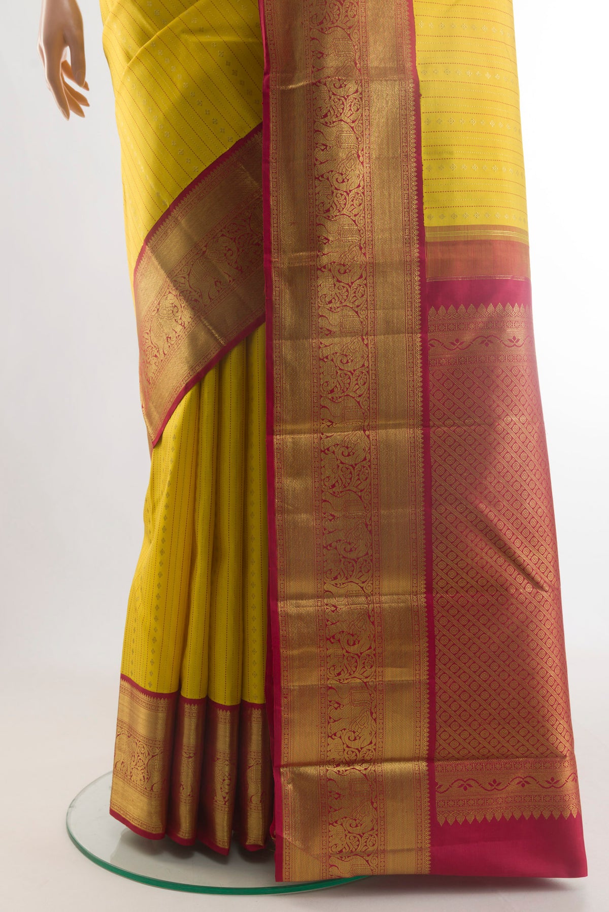 Pleats and pallu of Yellow Kanchipuram Silk Saree with Stripes on the body and Zari Border. 