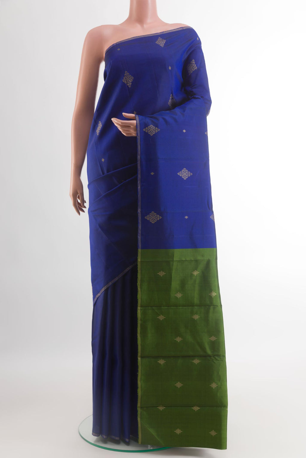 Blue Kanchipuram Silk Saree with Zari Butta on the body and Thin Zari Line.  displayed on a mannequin