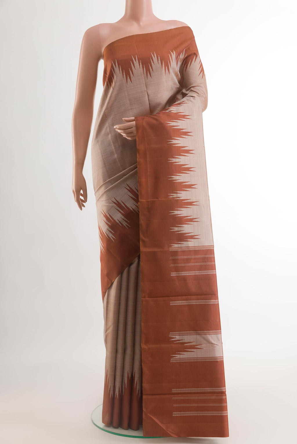 Cream Kanchipuram Silk Saree with Zari Butta on the body and Zari Border.  displayed on a mannequin