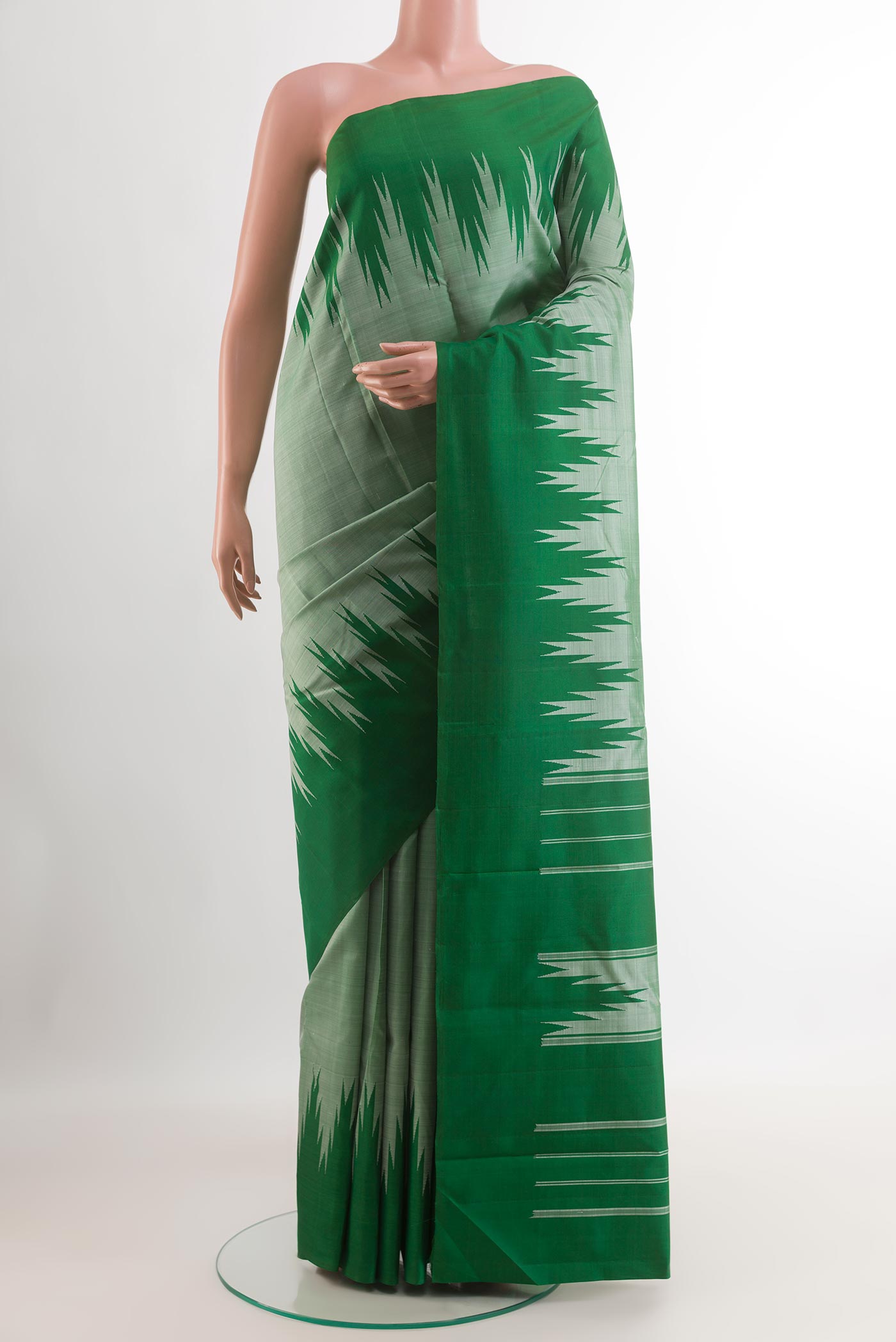 Sage Green Kanchipuram Silk Saree with Plain Body and Temple Border.  displayed on a mannequin