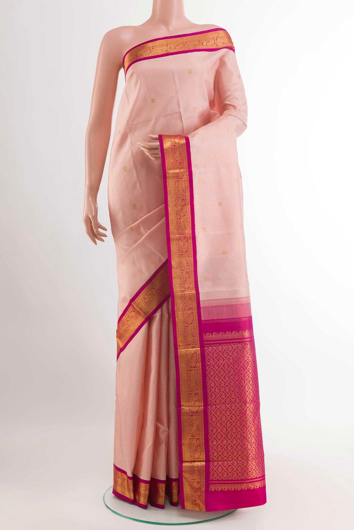 Rose pink Kanchipuram Silk Saree with Zari Butta on the body and Zari Border displayed on a mannequin