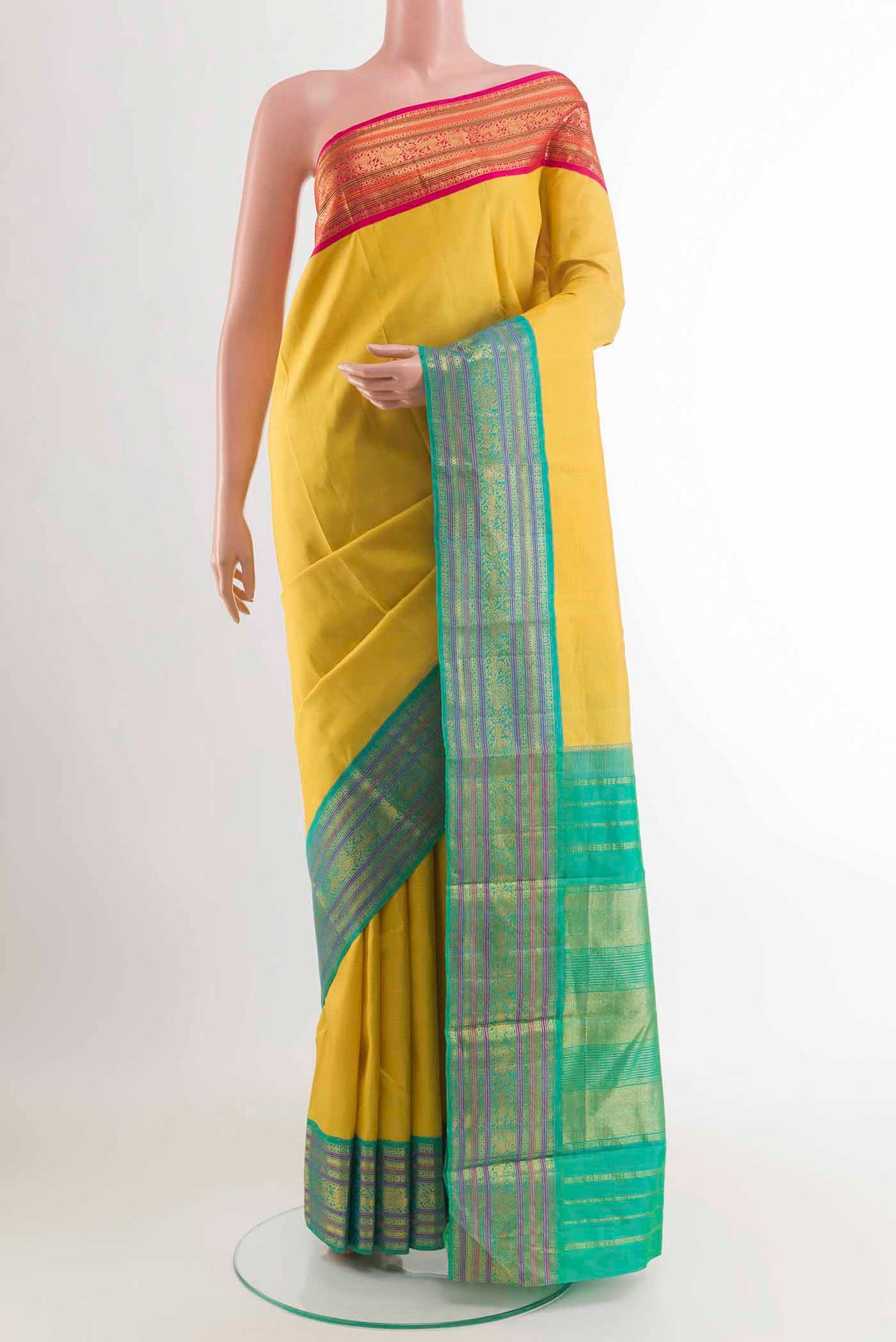 Yellow Kanchipuram Silk Saree with Zari Butta on the body and Ganga Jamuna Border displayed on a mannequin