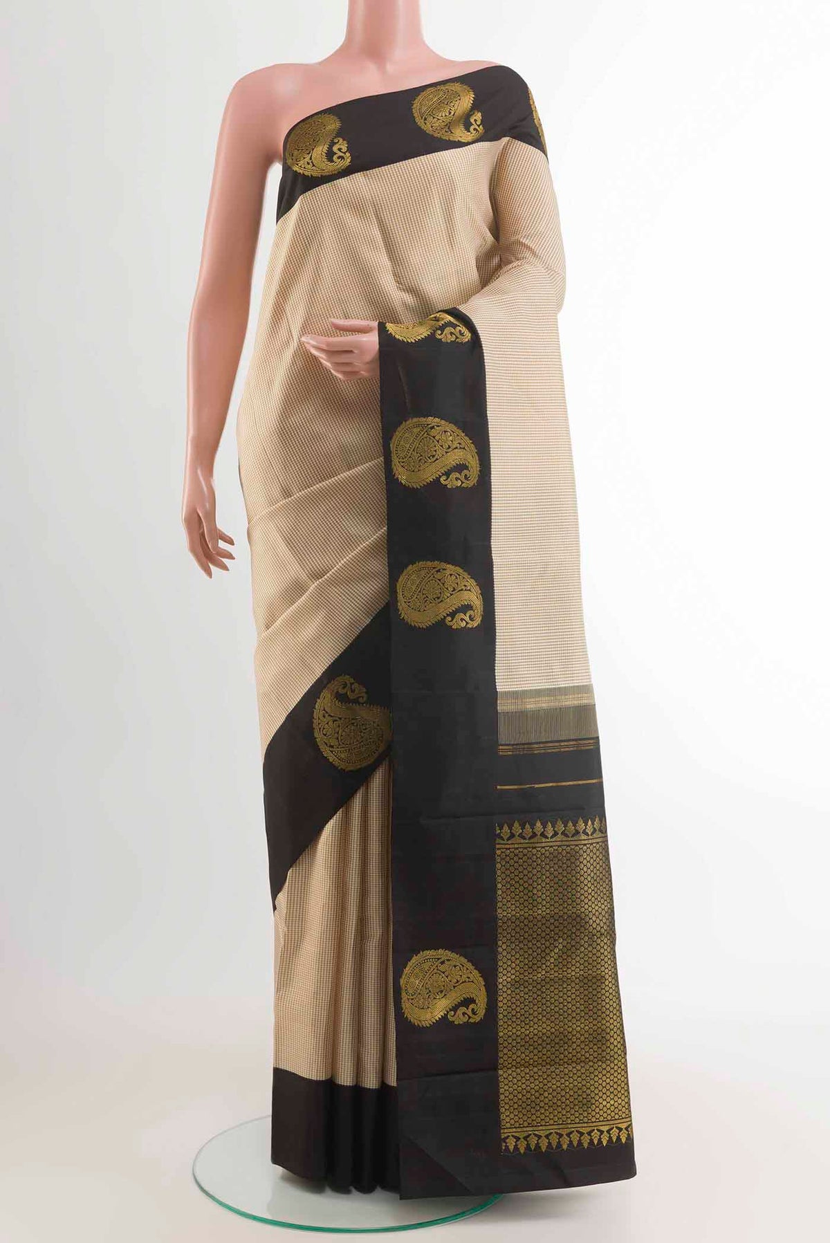 Off White Kanchipuram Silk Saree with Checked design on the body and Zari Border displayed on a mannequin