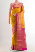 Yellow Kanchipuram Silk Saree with Thread Butta on the body and Zari Border displayed on a mannequin