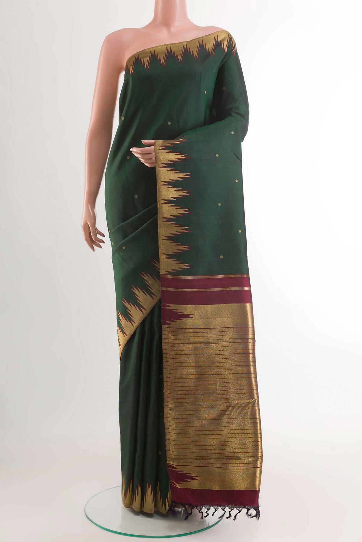 Bottle Green Kanchipuram Silk Saree with Zari Butta on the body and Zari Border displayed on a mannequin