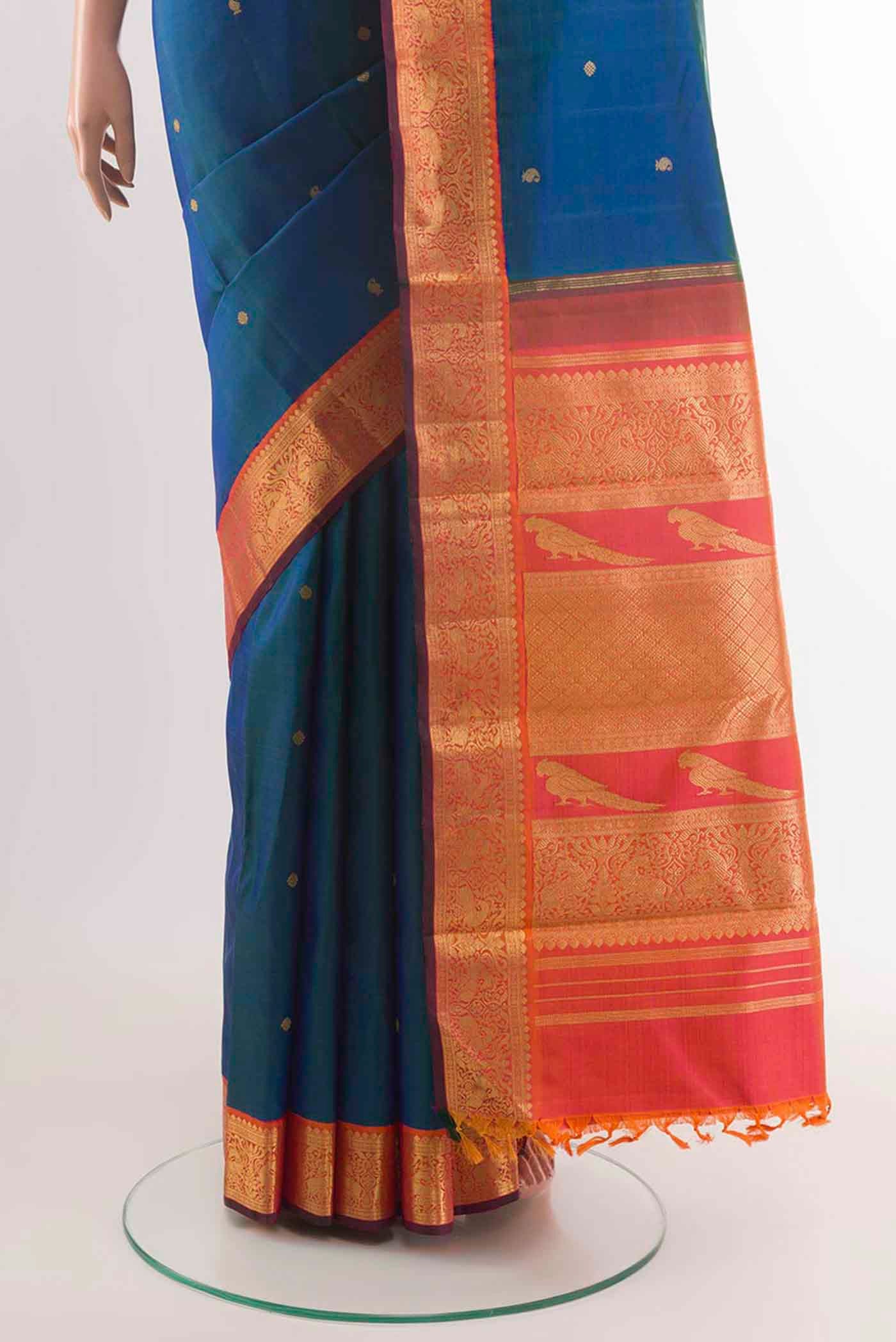 Pleats and pallu of Peacock Blue Kanchipuram Silk Saree with Zari Butta on the body and Zari Border