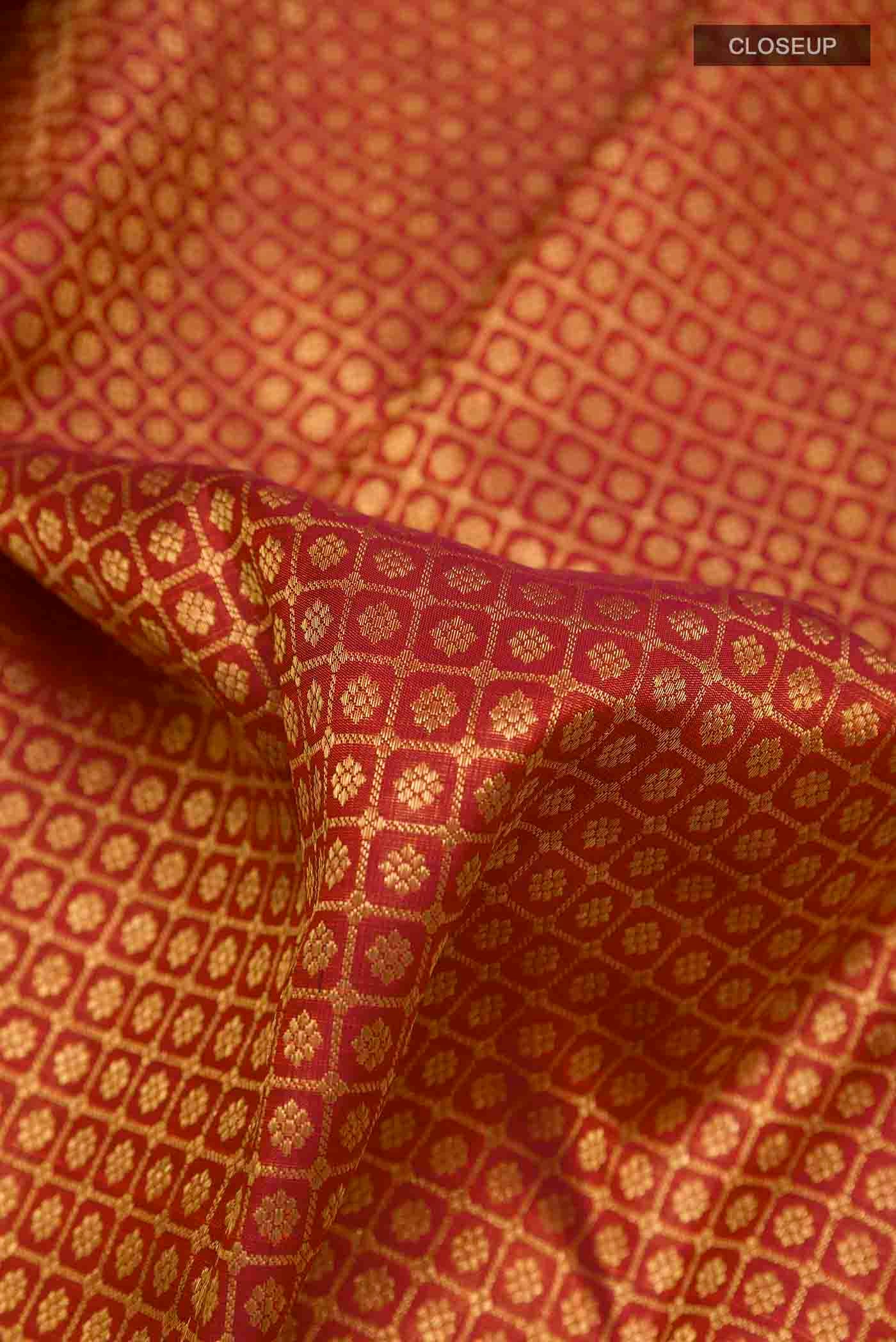 Close up of Maroon Kanchipuram Silk Saree with Zari Brocade on the body and Zari Border displaying folds