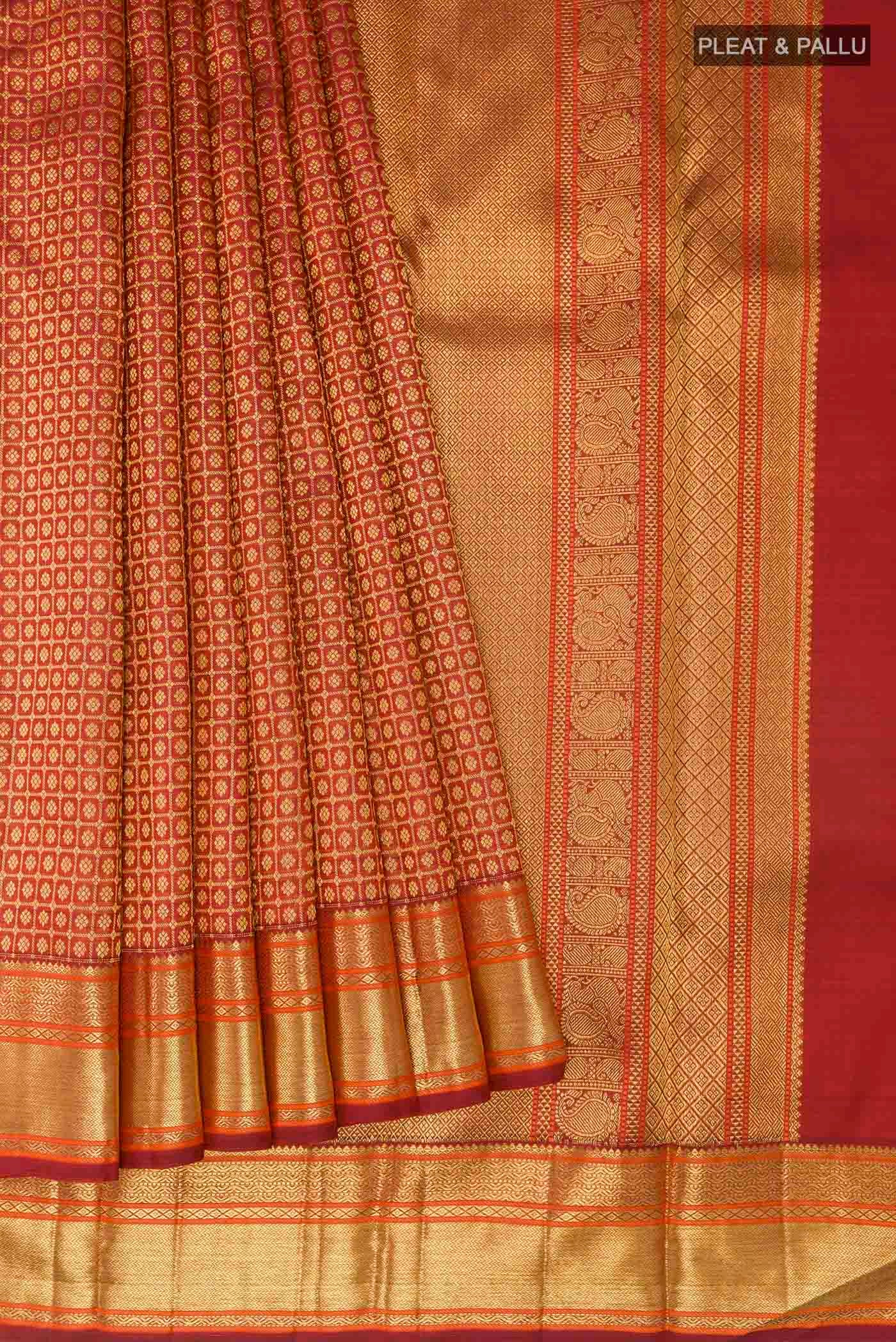 Pleats and pallu of Maroon Kanchipuram Silk Saree with Zari Brocade on the body and Zari Border