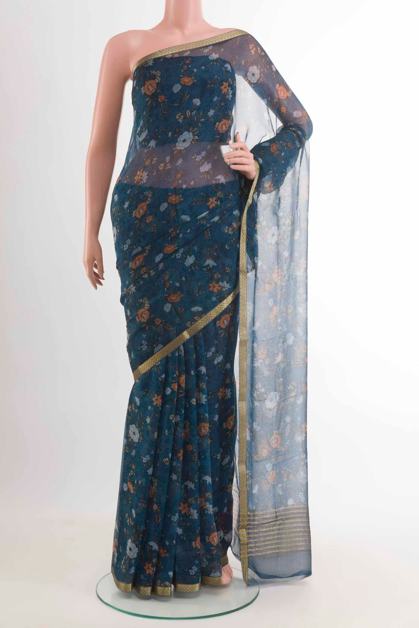 Blue Chiffon Saree with Printed design on the body and Zari Border displayed on a mannequin