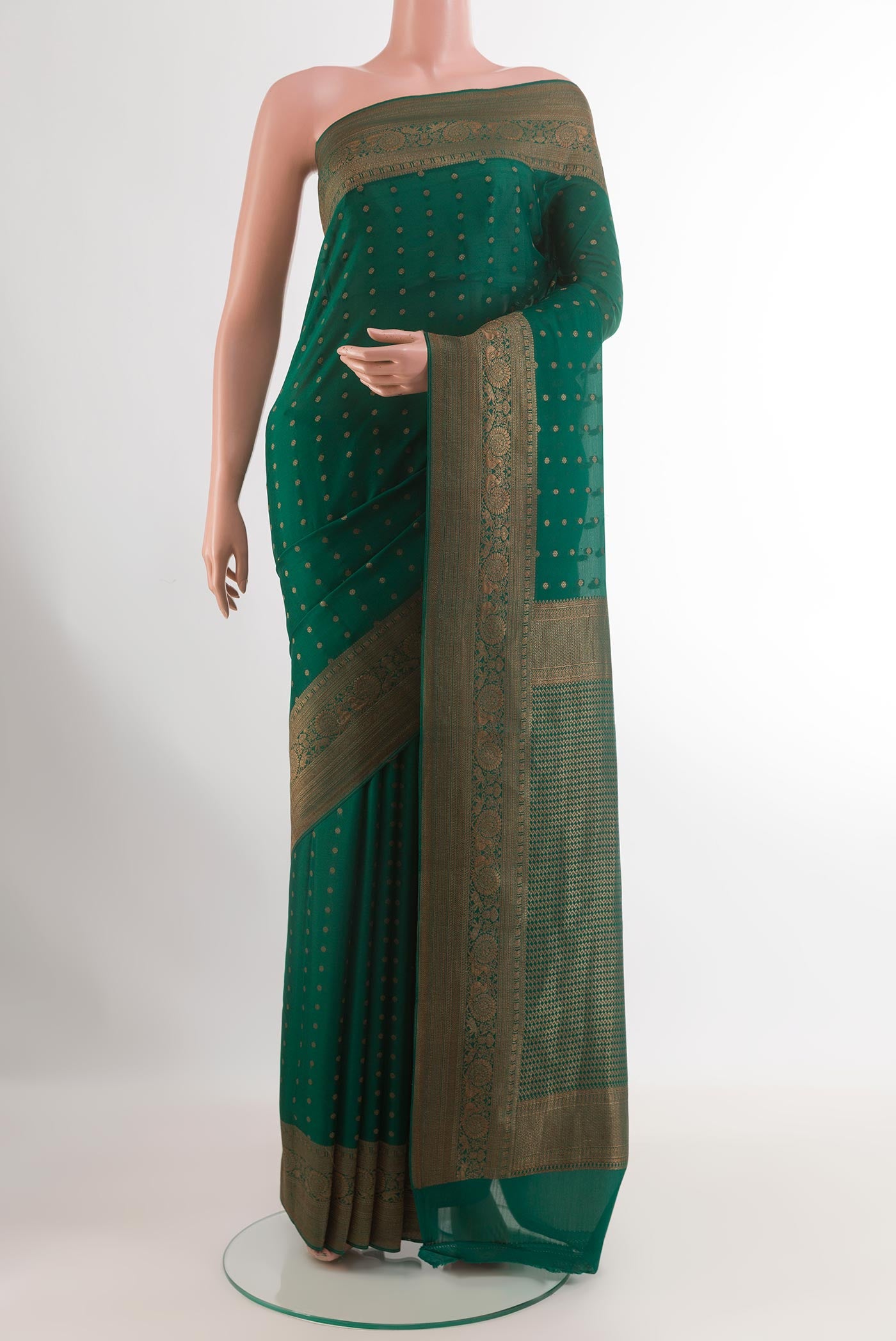 Green Mysore Crepe Saree with Zari Butta on the body and Zari Border.  displayed on a mannequin