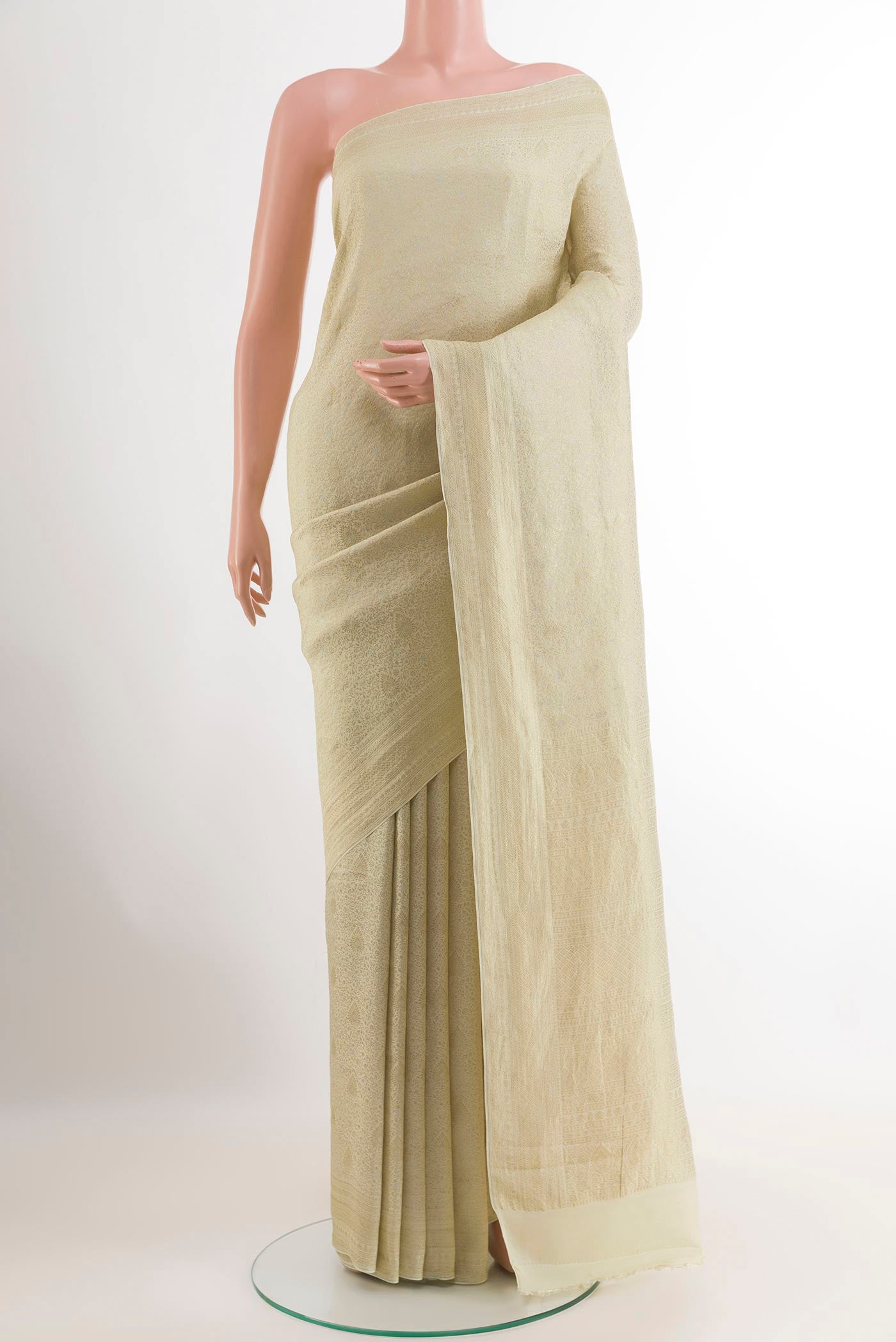 Off White Mysore Crepe Saree with Zari Brocade on the body and Zari Border.  displayed on a mannequin