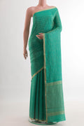 Sea Green Mysore Crepe Saree with Zari Brocade on the body and Zari Border.  displayed on a mannequin
