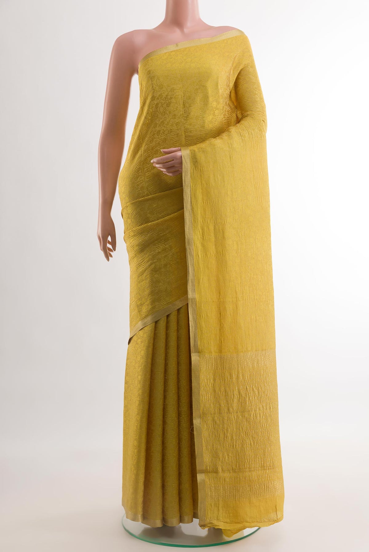 Mustard Mysore Crepe Saree with Zari Brocade on the body and Zari Border.  displayed on a mannequin