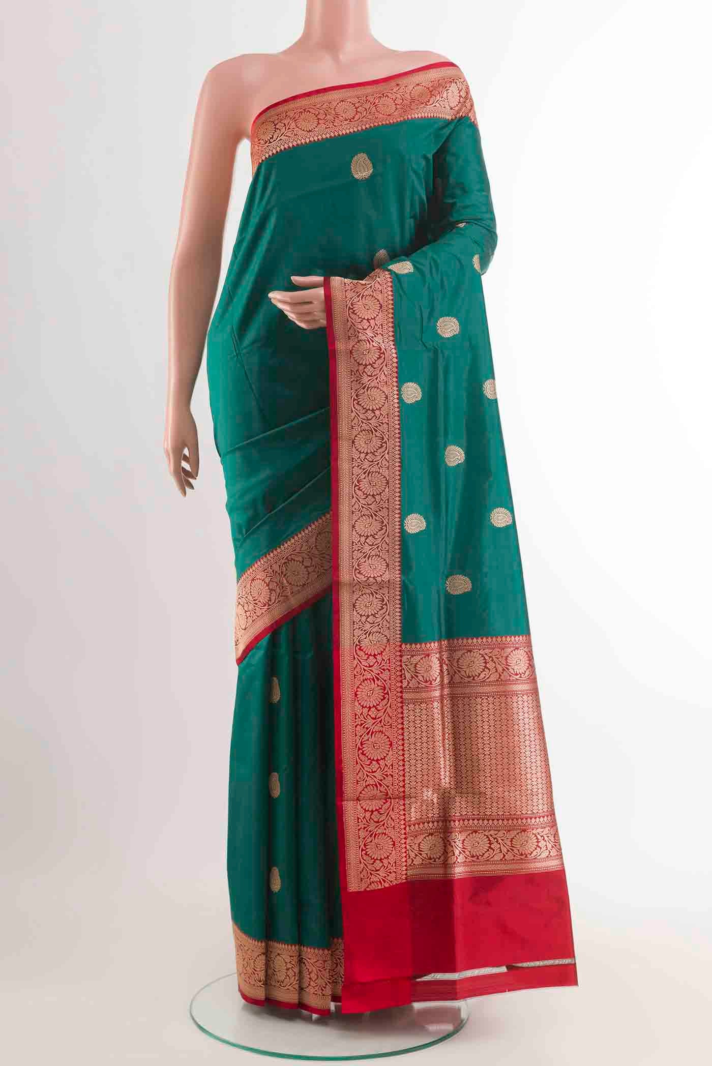Green Banarasi Katan Silk Saree with Zari Butta on the body and Zari Border displayed on a mannequin