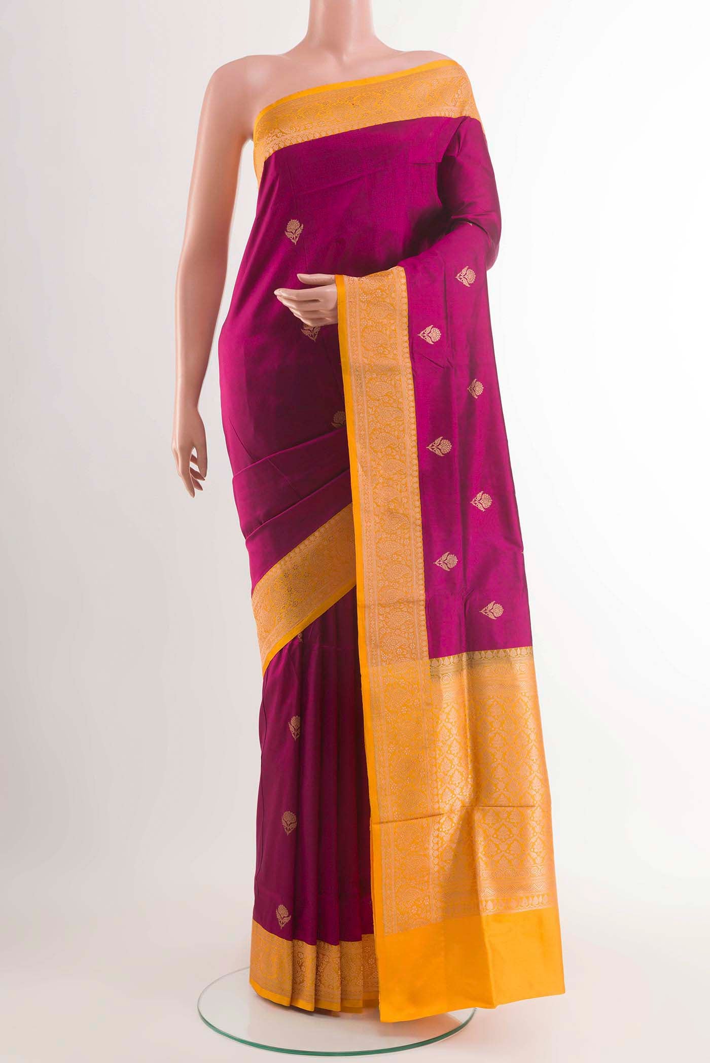 Magenta Banarasi Katan Silk Saree with Zari Butta on the body and Zari Border displayed on a mannequin