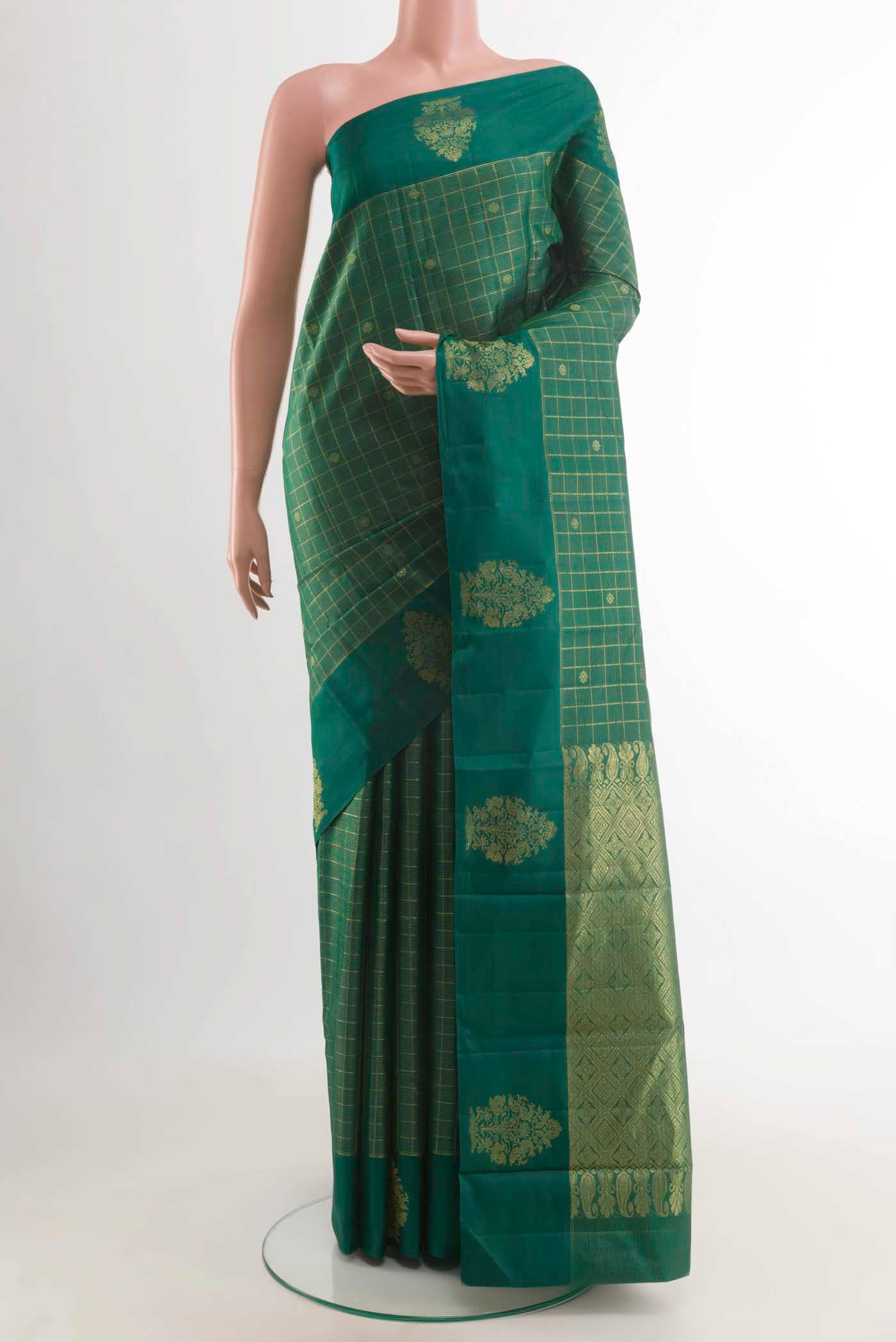 Bottle Green Kanchipuram Silk Saree with Zari Butta on the body and Zari Border displayed on a mannequin