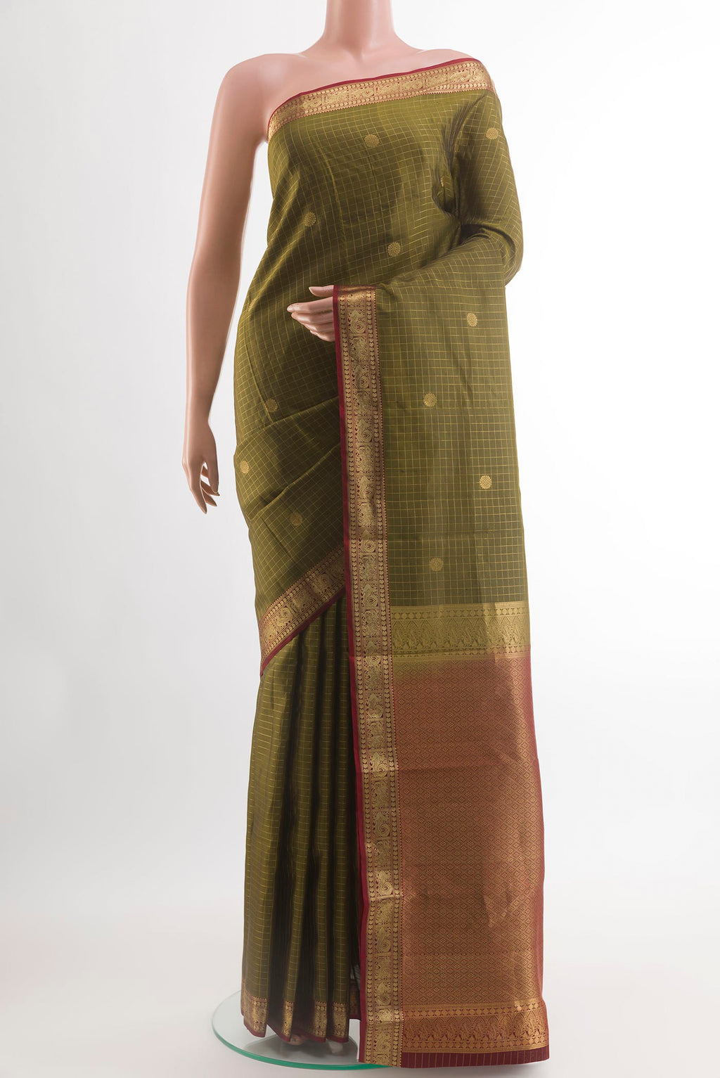 Mehandi Green Kanjivaram Silk Saree with Checked design on the body and Zari Border.  displayed on a mannequin