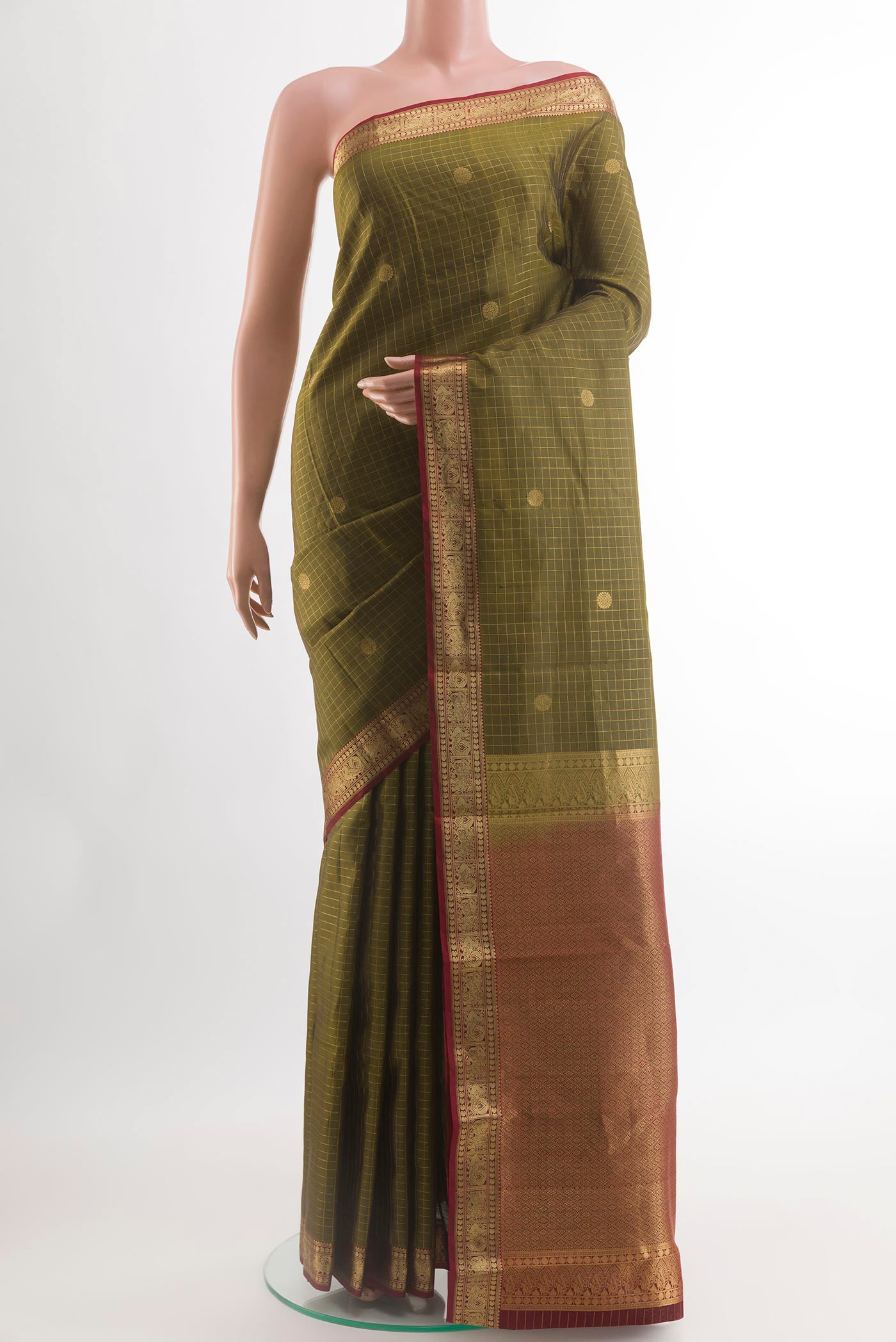 Mehandi Green Kanjivaram Silk Saree with Checked design on the body and Zari Border.  displayed on a mannequin