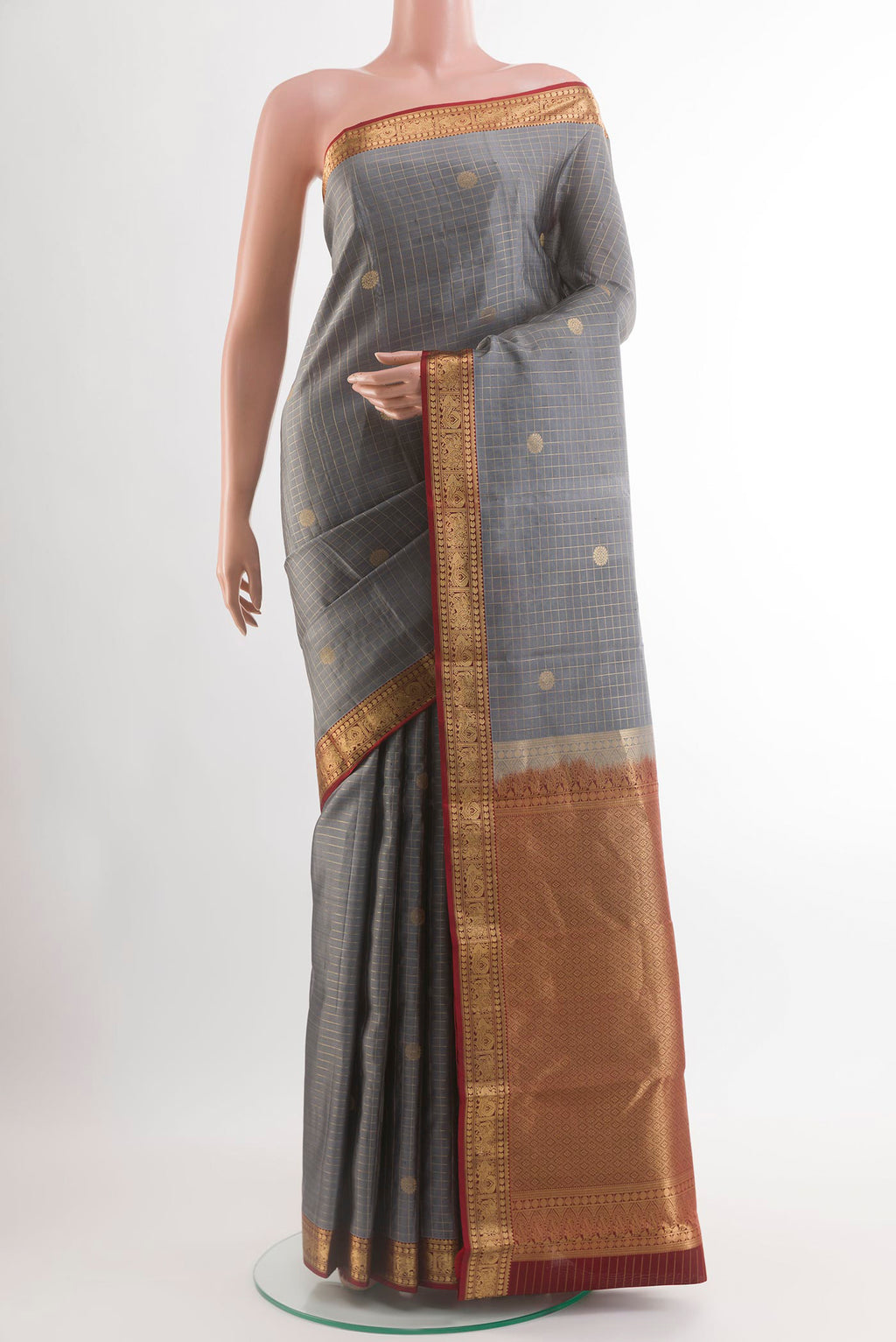 Grey Kanjivaram Silk Saree with Checked design on the body and Zari Border.  displayed on a mannequin