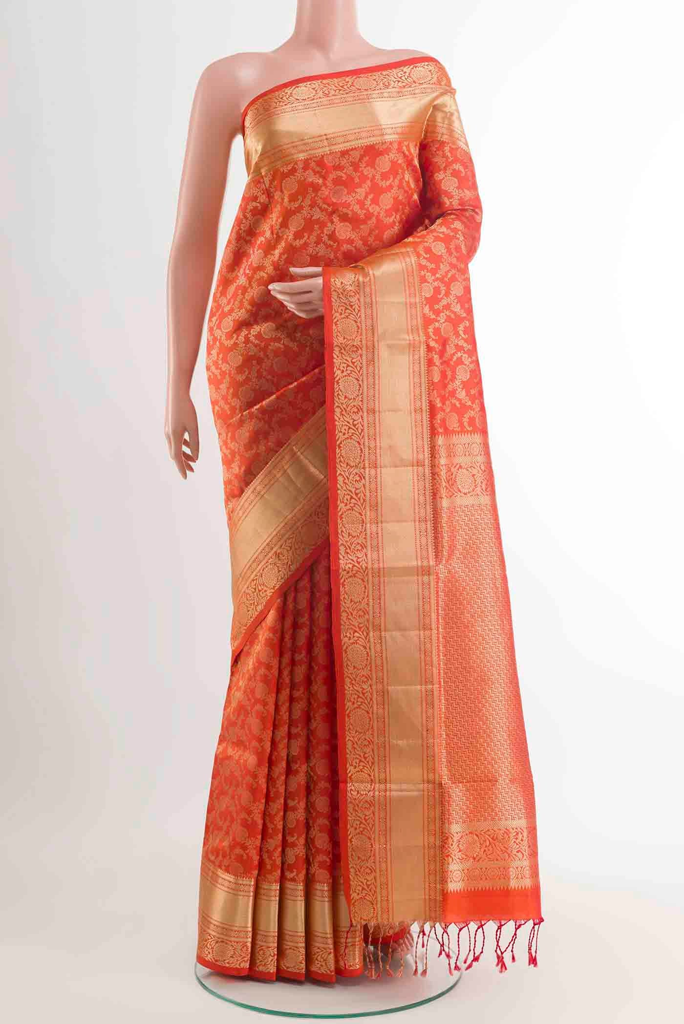Orange Soft Silk Saree with Zari Brocade on the body and Zari Border displayed on a mannequin